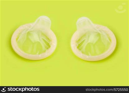 yellow condoms on green background