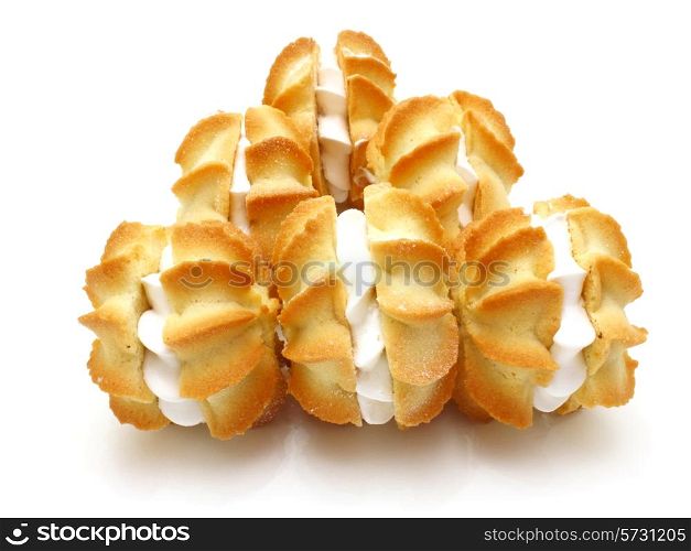 Yellow cookies with a white stuffing lie on a white background in the form of a circle