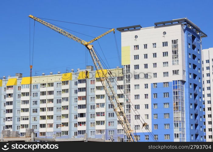 yellow crane and blue sky on building site