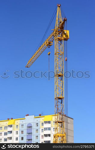 yellow crane and blue sky on building site