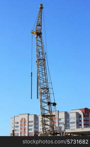 yellow crane and blue sky on building site