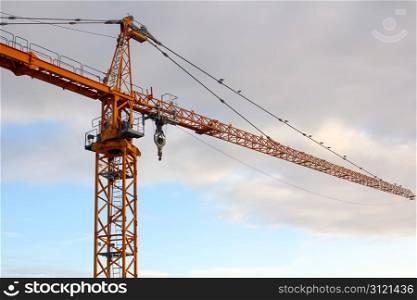 Yellow Crane In Front Of Sky and Clouds