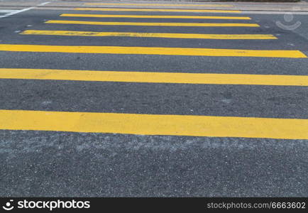 Yellow crosswalk on asphalt.. Yellow crosswalk on asphalt