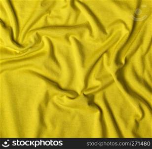 yellow crumpled cotton stretching soft fabric, full frame
