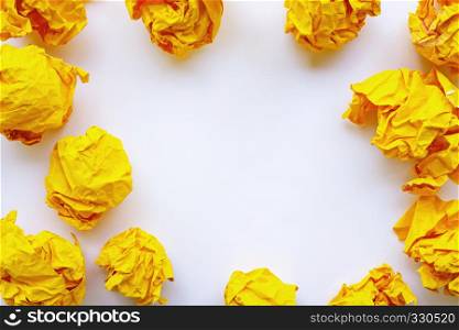 Yellow crumpled paper ball isolated on white background. Copy space