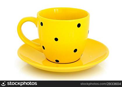 Yellow cup and saucer on the white background