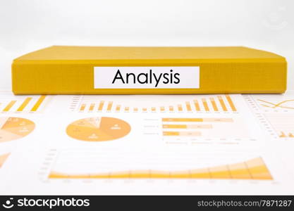 Yellow document binder with analysis word place on graphs, charts and business reports