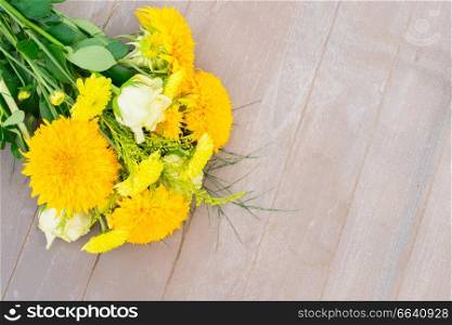 Yellow fall bouquet on gray wooden table. Yellow fall bouquet