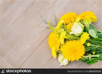 Yellow fall bouquet on wooden table with copy space. Yellow fall bouquet