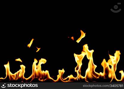 yellow fire with flame tongues isolated on black
