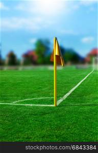 Yellow flag in corner of football playground, blurred concept