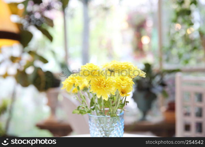 yellow flower in jar