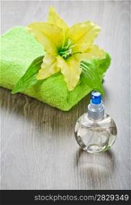 yellow flower on towel and transparent bottle
