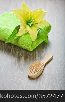 yellow flower on towel with hairbrush