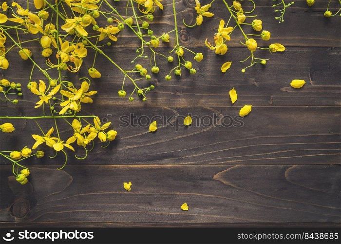 Yellow flower on wooden background with space with vintage toned.