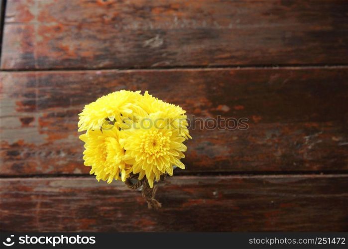 yellow flowers on wood background