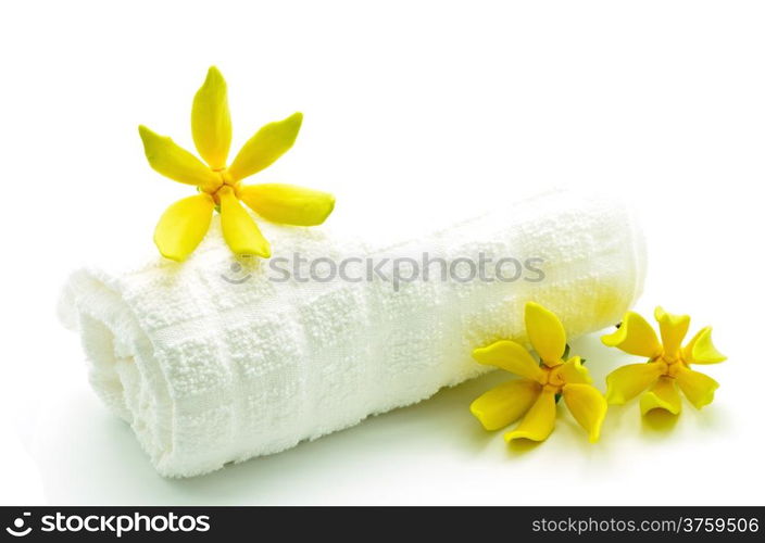 Yellow fragrant flower, Ylang-Ylang flower (Cananga odroata) with towel in spa theme, isolated on a white background