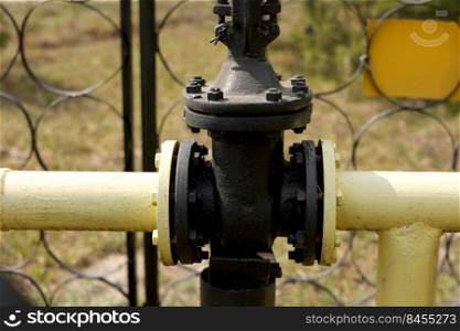 Yellow gas pipes and valves outdoors. gas equipment. Copy space for text. High quality photo.. Yellow gas pipes and valves outdoors. gas equipment. Copy space for text. High quality photo
