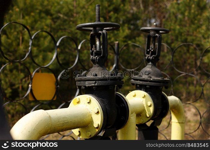 Yellow gas pipes and valves outdoors. gas equipment. Copy space for text. High quality photo.. Yellow gas pipes and valves outdoors. gas equipment. Copy space for text. High quality photo