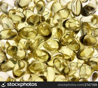 Yellow gel capsules with medicine in them.. Yellow Gel Capsules