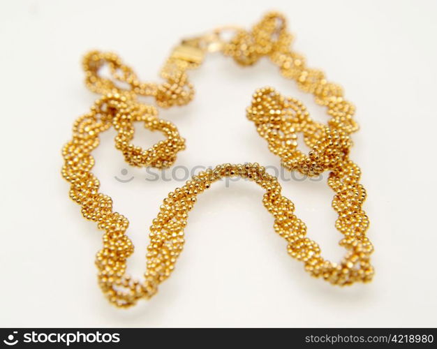 Yellow gold jewellry, isolated towards white background