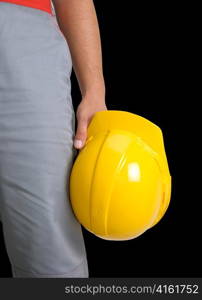 Yellow helmet at man hands isolated on a black