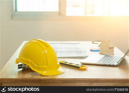 Yellow helmet is on the engineer&rsquo;s desk. Safety helmets for technicians are engineers or construction workers.