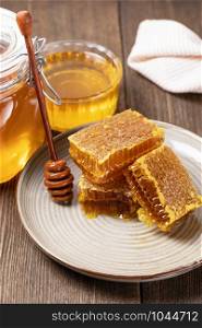 Yellow Honey and Honeycomb slice on a wooden table. Honey and Honeycomb slice