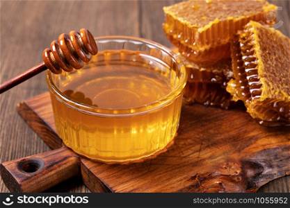 Yellow Honey and Honeycomb slice on a wooden table. Honey and Honeycomb slice