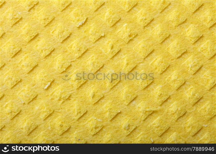 Yellow kitchen sponge rubber foam as background texture