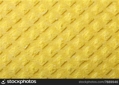 Yellow kitchen sponge rubber foam as background texture