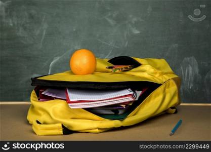yellow knapsack with copybooks orange