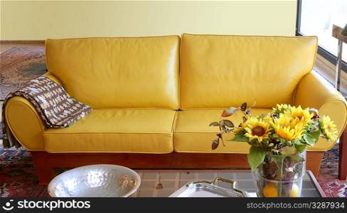 Yellow leather sofa couch interior sunflower bouquet