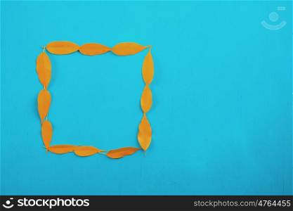 Yellow Leaves With Square Shape On Wood Table