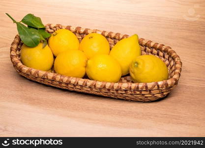 yellow lemons in a small wooden basket