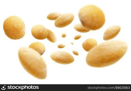 Yellow lentils levitate on a white background.. Yellow lentils levitate on a white background