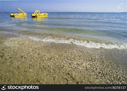 Yellow lifeboat on the beach. Italian beach