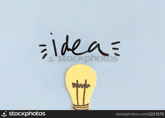 yellow light bulb with idea word blue background