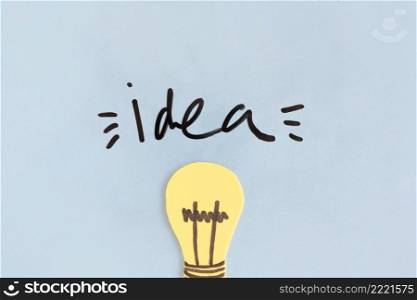 yellow light bulb with idea word blue background