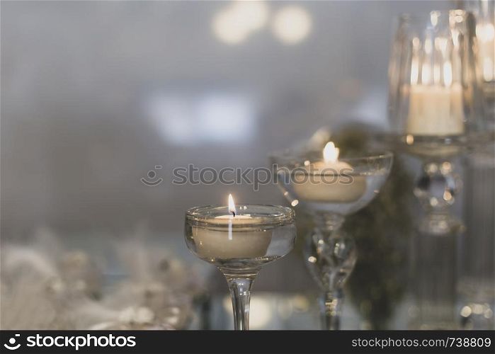 Yellow light-emitting candle in glass