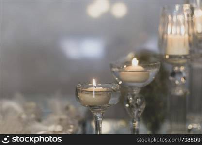 Yellow light-emitting candle in glass