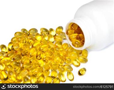 Yellow liquid capsules lie near a bottle