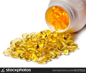 Yellow liquid capsules lie near a bottle