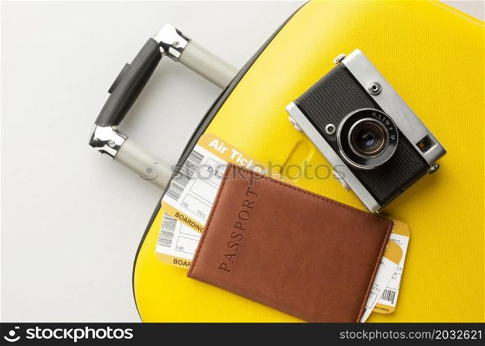yellow luggage with camera passport