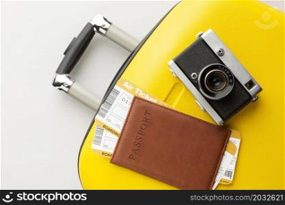 yellow luggage with camera passport