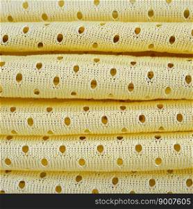 Yellow mesh sport wear fabric textile pattern background. Yellow color football jersey clothing fabric texture sports wear. Breathable porous poriferous material air ventilation with small holes. Yellow mesh sport wear fabric textile background pattern