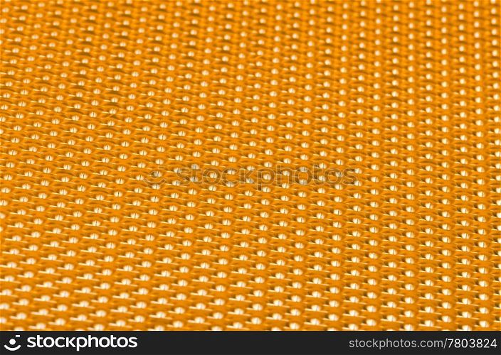 Yellow metal mesh plating isolated against a white background