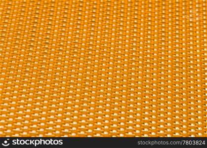 Yellow metal mesh plating isolated against a white background