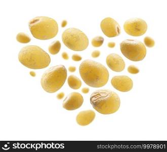Yellow millet in the shape of a heart on a white background.. Yellow millet in the shape of a heart on a white background