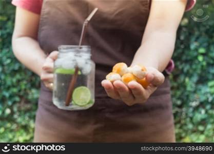 Yellow mini cakes and lime Infused detox water, stock photo